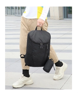 Close-up of black waterproof folding backpack with durable nylon fabric and storage pouch