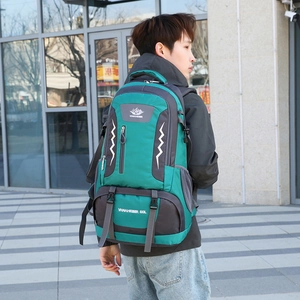 Green and grey 60L outdoor hiking backpack with ergonomic straps shown on model