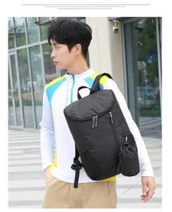 Detail of waterproof black travel backpack with side mesh pocket and detachable drawstring pouch