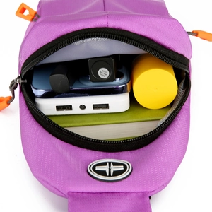 Purple waterproof oxford chest bag showing main compartment with essentials inside