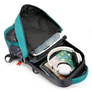 Large capacity outdoor hiking backpack showing spacious interior with clothes and tablet