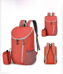 Detail view of red waterproof foldable backpack with matching drawstring storage pouch