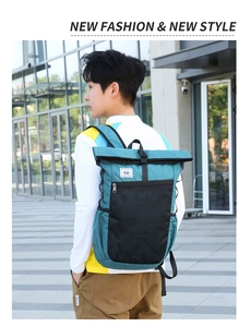 Detail view of lightweight foldable backpack with roll-top closure on outdoor male model