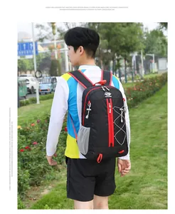 Detail of lightweight hiking backpack featuring red zipper pulls and elastic bungee cords