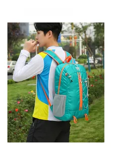 Detail of teal outdoor backpack with orange accents, mesh side pockets and elastic cords