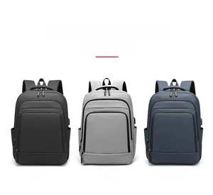 Business laptop backpacks in black, grey, and blue with external USB charging ports