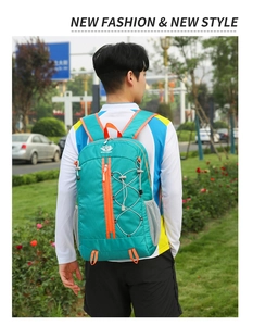 Close-up of waterproof outdoor backpack with turquoise and orange color-blocking detail