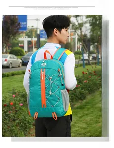 Close-up of lightweight lake blue hiking backpack with orange zippers and side mesh pockets