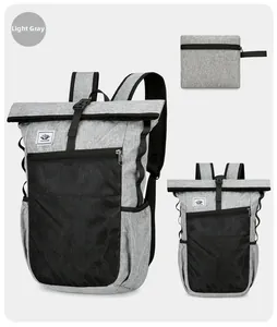 Light grey ultralight foldable backpack with roll-top closure and mesh front pocket