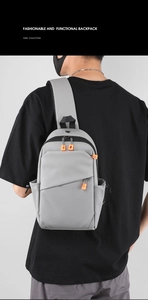 Vue détaillée arrière d'un sac de poitrine gris avec détail de fermeture orange