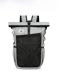Front view of grey waterproof folding backpack featuring roll-top closure and mesh pocket