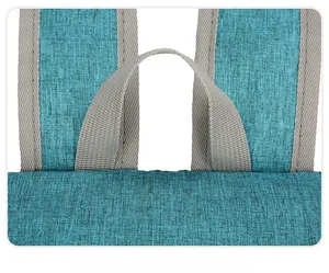 Close-up of the reinforced top handle and woven fabric detail on the travel backpack