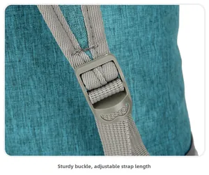 Detail view of the sturdy grey plastic buckle and adjustable nylon strap on a blue backpack