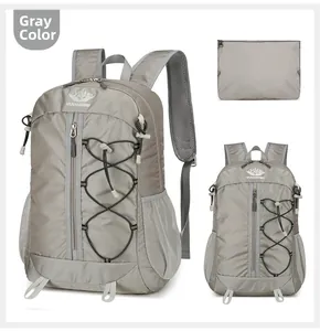 Detail view of grey lightweight foldable outdoor backpack with mesh pockets and storage pouch
