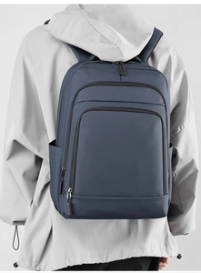 Men's navy waterproof nylon backpack on a grey hoodie for urban commute and business
