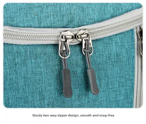 Close-up of durable two-way zippers with anti-slip pullers on water-resistant blue fabric