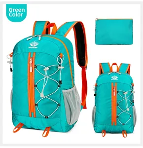 Detail of teal outdoor backpack featuring waterproof nylon, orange zippers and bungee cord