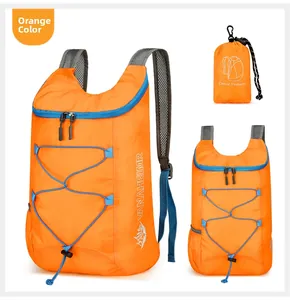 Foldable orange hiking backpack detail showing the portable storage pouch and mesh straps