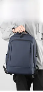 Detail of dark blue waterproof commuter backpack with top handle and functional zippers