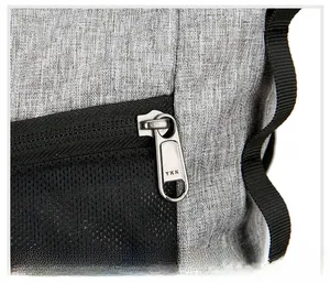 Detailed macro view of YKK metal zipper and gray fabric texture on a foldable backpack