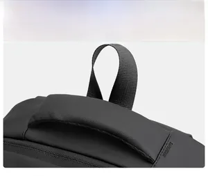 Macro shot of durable nylon backpack showing reinforced double handles and zipper seal