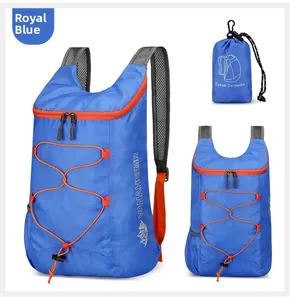 Detail view of sapphire blue foldable travel backpack with orange zippers and mesh side pockets