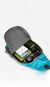 Detail view of large storage capacity in a blue hiking chest bag with travel essentials