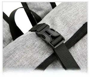 Close-up of durable black plastic buckle and grey textured fabric on the folding backpack