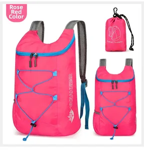 Detailed view of rose red foldable backpack showing mesh straps and storage pouch
