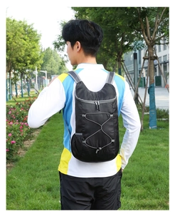Outdoor lifestyle shot of a lightweight black foldable backpack with breathable mesh straps