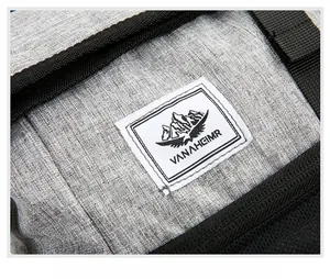 Macro detail of VANAHEIMR logo patch on lightweight gray outdoor folding backpack