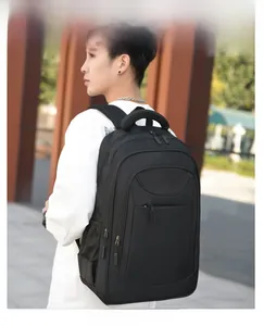 Outdoor model shot of a large black business backpack with multiple zipper pockets