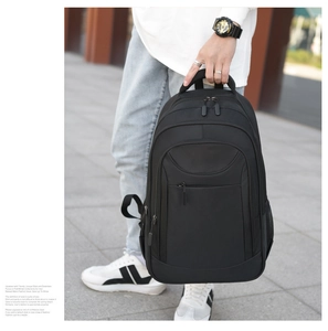 Outdoor shot of a black business commuter backpack with multiple zipper pockets and side pockets