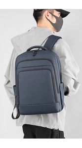 Deep blue minimalist laptop backpack featuring functional multi-layer zipper pockets