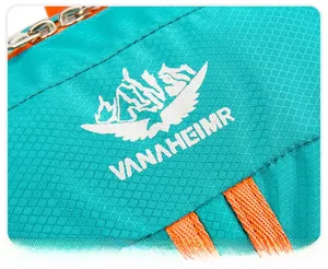 Macro shot of VANAHEIMR outdoor backpack showing blue ripstop nylon fabric and logo