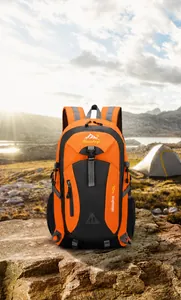 Outdoor 40L hiking backpack in orange and grey on a rocky mountain lake background