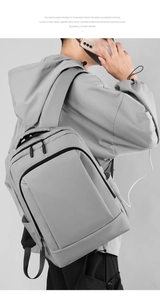 Detail of gray business backpack with built-in USB charging port and sleek waterproof fabric