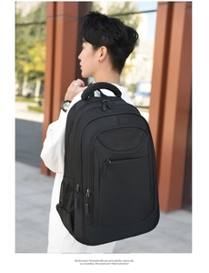 Outdoor street view of a black business backpack with large capacity and multi-pocket design