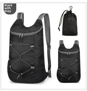 Detail view of foldable nylon backpack in black and grey with its compact storage pouch