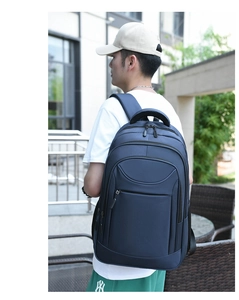 Detailed view of deep blue waterproof business backpack with multiple zipper compartments