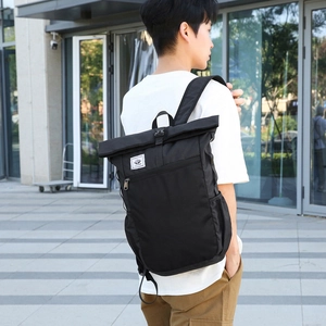 Lightweight black waterproof folding backpack for hiking and travel shown in street view
