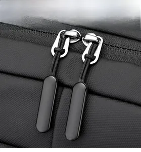Macro detail of high-quality double metal zippers on black honeycomb texture backpack
