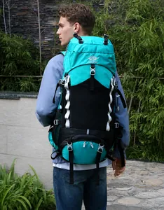 60L outdoor hiking backpack in blue and black being worn by a person in a scenic setting
