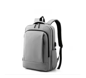 Close-up of light gray waterproof laptop backpack featuring an external USB charging port