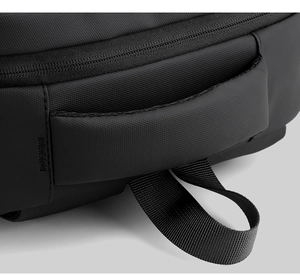 Detail macro view of heavy-duty reinforced handle and nylon webbing on black backpack