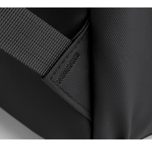 Macro shot of reinforced stitching and durable honeycomb texture on a black backpack strap