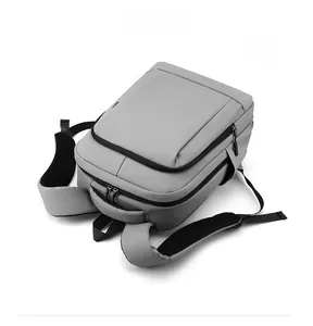 Front view of grey water-resistant commuter backpack with black zippers and padded straps