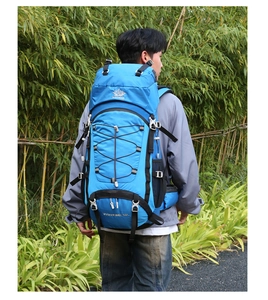 Blue 60L hiking backpack with durable straps shown on male model in bamboo forest
