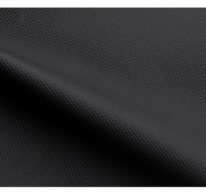 Macro shot of black synthetic fabric with honeycomb texture on a men's backpack