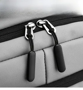 Detail view of the durable gray fabric texture and premium silver double metal zippers